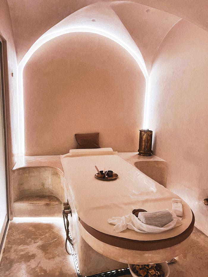 Luxurious spa massage room featuring minimalist interior design and ambient lighting.